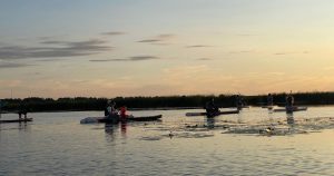 A trip with SUP boards on Lake Babīte at sunset and sunrise. Relaxation in nature in Remeši with SUP boards, boats and holiday houses.